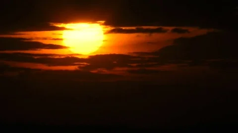 The sun moves down to a sunset in an aperture from dark clouds. 動画素材 70071603