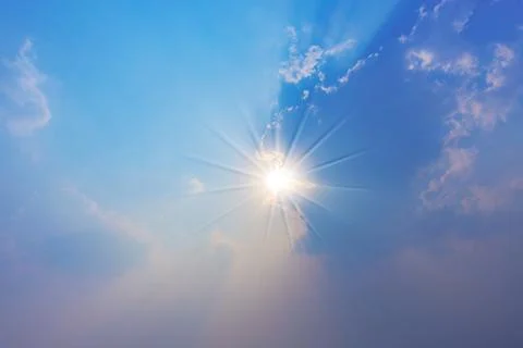 The sun moves from white clouds in the evening. Stock Photos