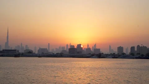 Sun Moving behind the silhouette of skylines in evening Stock Footage 232533756