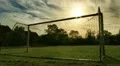 Sun moving behind soccer goalposts in Europe HD Footage