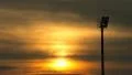 Sun moving past Floodlights HD Footage