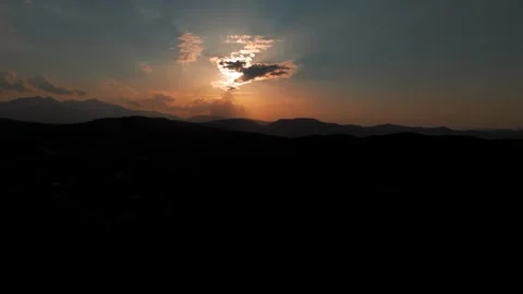 Sun Obscured by Clouds Over Mountain Landscape During Solar Eclipse at Dusk Stock Footage 344441030