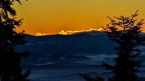 Sun at the orange sky setting behind the hill Stock Footage 132242318