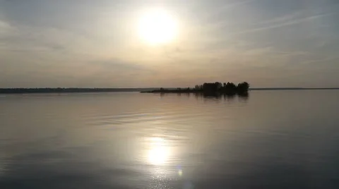Sun over island on a lake Stock Footage 54408830