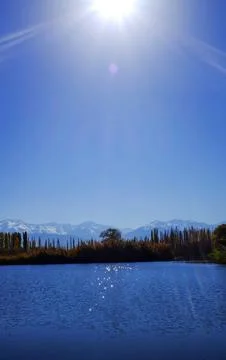 The sun over the lake, vertical photo. Stock Photos
