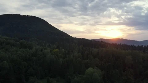 Sun over mountain ridges aerial.Forest and cloudy colorful sky during sunset Stock Footage 249192528