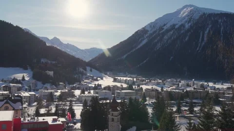 The sun over the mountains above Davos in winter 스톡 동영상 345299413
