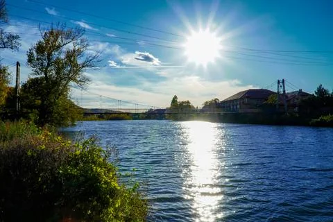 Sun over the river , sunset , evening landscape , glare on the water Stock Photos