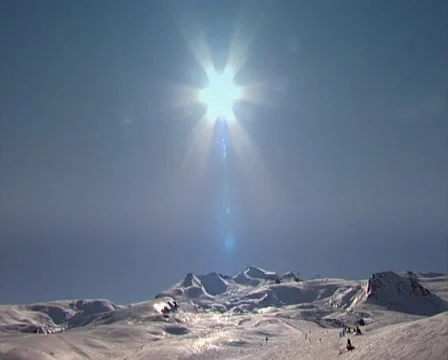 Sun over ski slopes Stockbeeldmateriaal 1848593