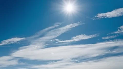 Sun over white clouds at blue sky aerial view. Bright light sun shine at fluffy Stock Photos