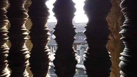  the sun passes through the Windows with carved columns of the temple of Angkor  Stock Footage 105878170