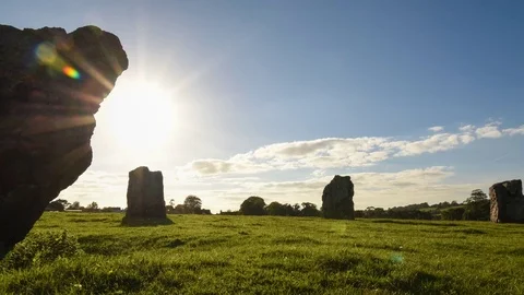 Sun passing neolithic stone circle henge with starburst and lens flare Stock Footage 69960449