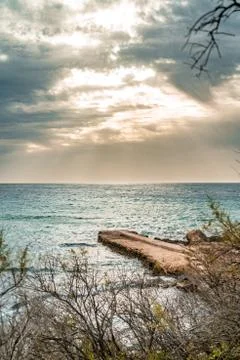 Sun passing thru the clouds over ocean pier, Malta Stock Photos