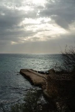 Sun passing thru the clouds over ocean pier, Malta Stock Photos