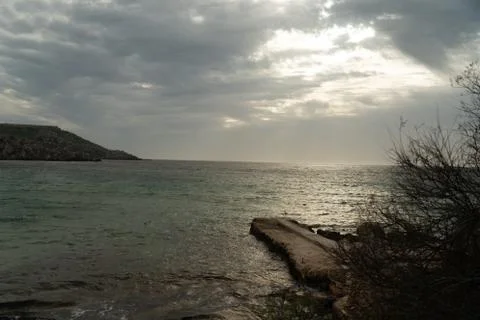 Sun passing thru the clouds over ocean pier, Malta 스톡 사진