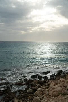 Sun passing thru the clouds over ocean pier, Malta Stock Photos