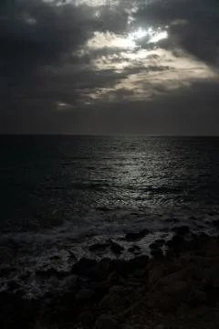 Sun passing thru the clouds over ocean pier, Malta Stock Photos