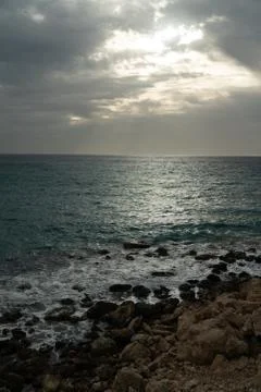 Sun passing thru the clouds over ocean pier, Malta Stock Photos