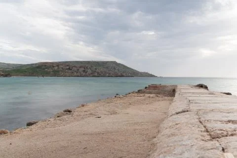 Sun passing thru the clouds over ocean pier, Malta Stock Photos