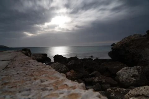 Sun passing thru the clouds over ocean pier, Malta Stock Photos