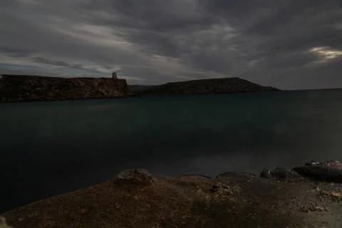 Sun passing thru the clouds over ocean pier, Malta Stock Photos