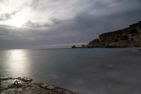 Sun passing thru the clouds over ocean pier, Malta Stock Photos