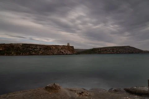 Sun passing thru the clouds over ocean pier, Malta Stock Photos