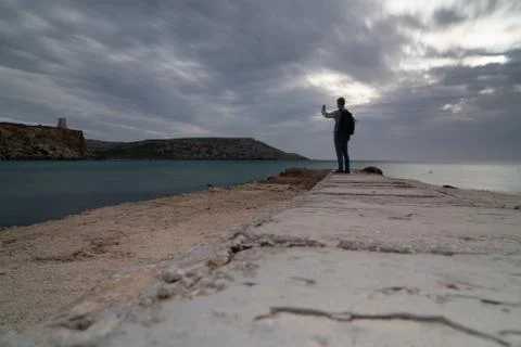 Sun passing thru the clouds over ocean pier, Malta Stock Photos