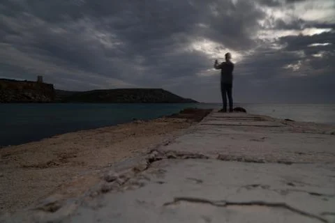 Sun passing thru the clouds over ocean pier, Malta Stock Photos