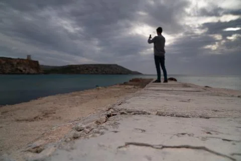 Sun passing thru the clouds over ocean pier, Malta Stock Photos