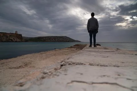 Sun passing thru the clouds over ocean pier, Malta Stock Photos