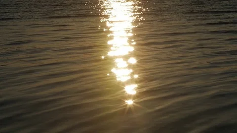 Sun path. High-contrast shot with light reflection in the water before the Stock Footage 82504489