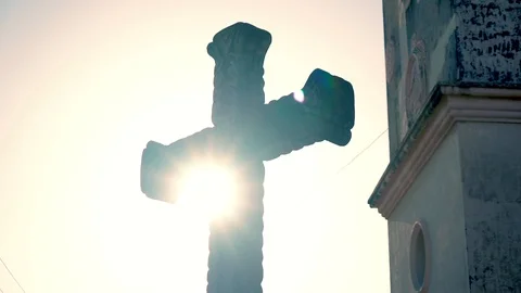 Sun peaking out behind cross Stock Footage 120138060