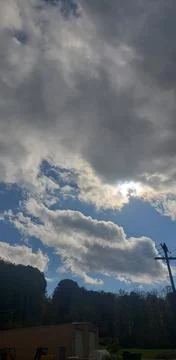 Sun Peaking Through Dark Clouds Stock Photos