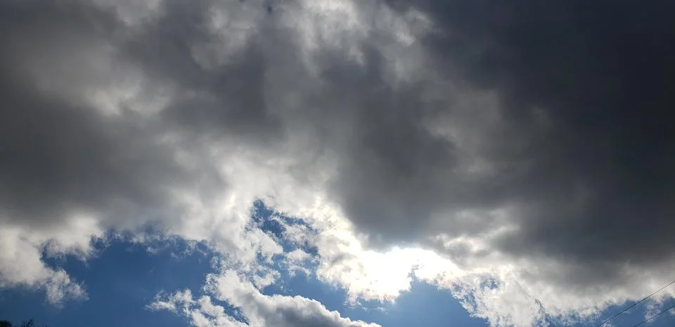 Sun Peaking Through Dark Clouds Stock Photos
