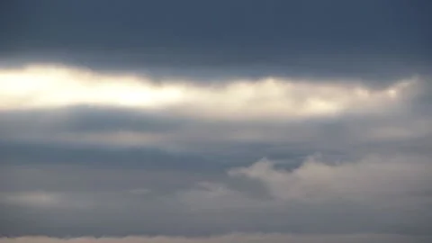 Sun peaking through dark thick clouds Stock Footage 144369320