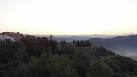 Sun peaks over mountains during dawny sunrise Stock Footage 97224043
