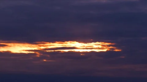 The sun peaks through stormy clouds at sunset Stock Footage 74006600