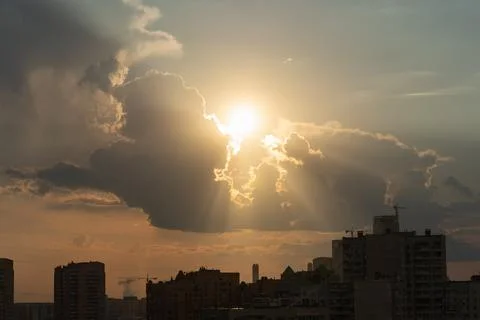 The sun is peeking out from behind the clouds. Stock Photos
