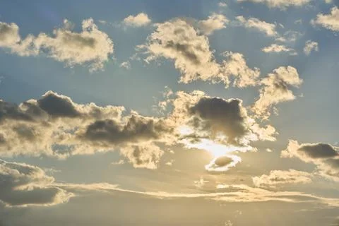 The sun is peeking out from behind the clouds. Stock Photos