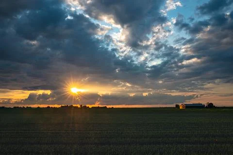 The sun is peeking through the clouds, just before sundown Stock Photos