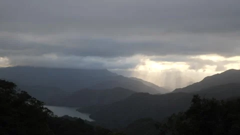 Sun Peeking Through Clouds on Majestic Mountains Landscape 4K Nature Video Video stock 295770980