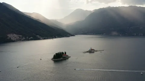 Sun peeking through clouds over Boka Kotor Bay in Perast Montenegro Stock Footage 138129595