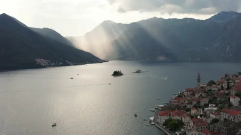 Sun peeking through clouds over Boka Kotor Bay in Perast Montenegro Stock Footage 138130464