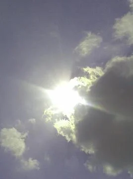 Sun Peeking Through Clouds Stock Photos