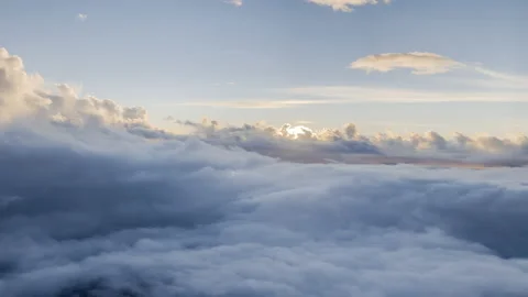 Sun peeks through evening clouds while flying along Stock Footage 168597542