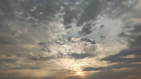 SUN PEEPING OUT BEFORE RISING FROM CLOUDS Video stock 238878328
