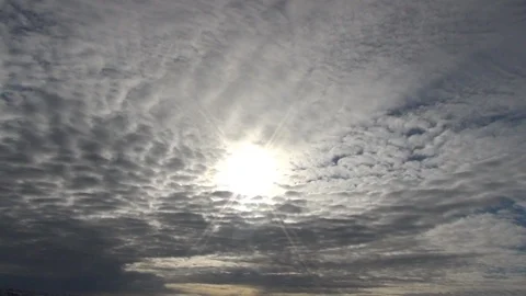 Sun piercing through a wide cloudy sky Stock Footage 104855011
