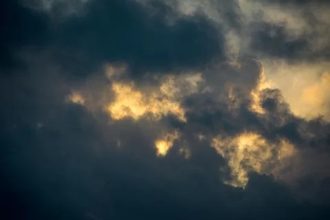 Sun Poking Through Dark Clouds Stock Photos