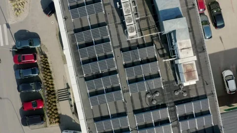 Sun-Powered Rooftop Solar Field In Modern Metropolis Viewed In Drone Flyover Stock Footage 314114854